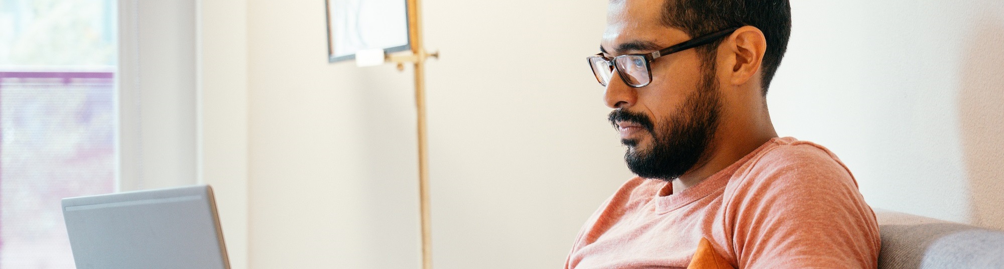 Man browsing on his laptop at home