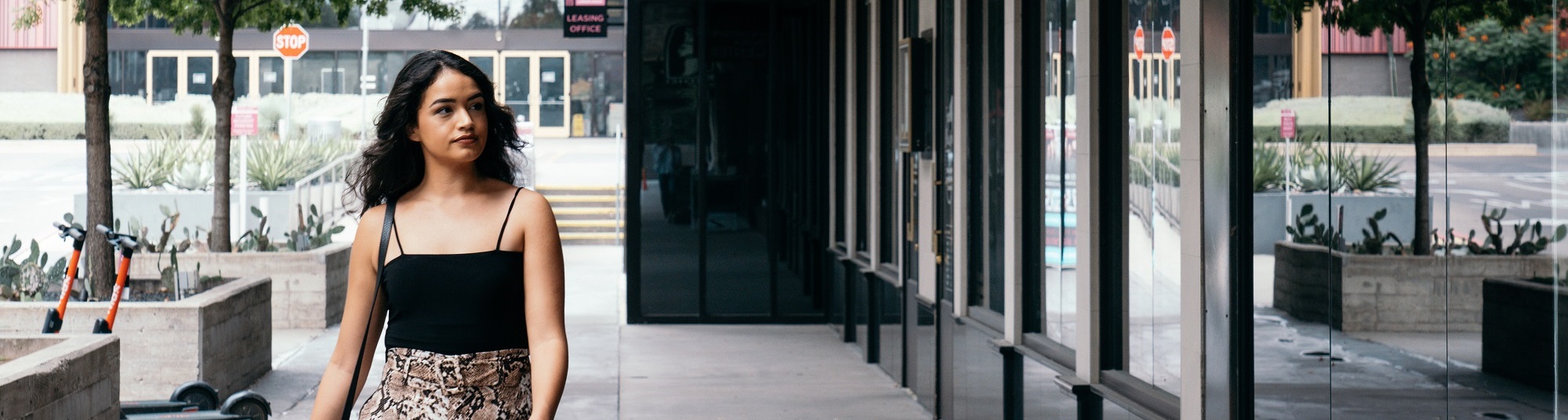 Woman walking down plaza browsing stores