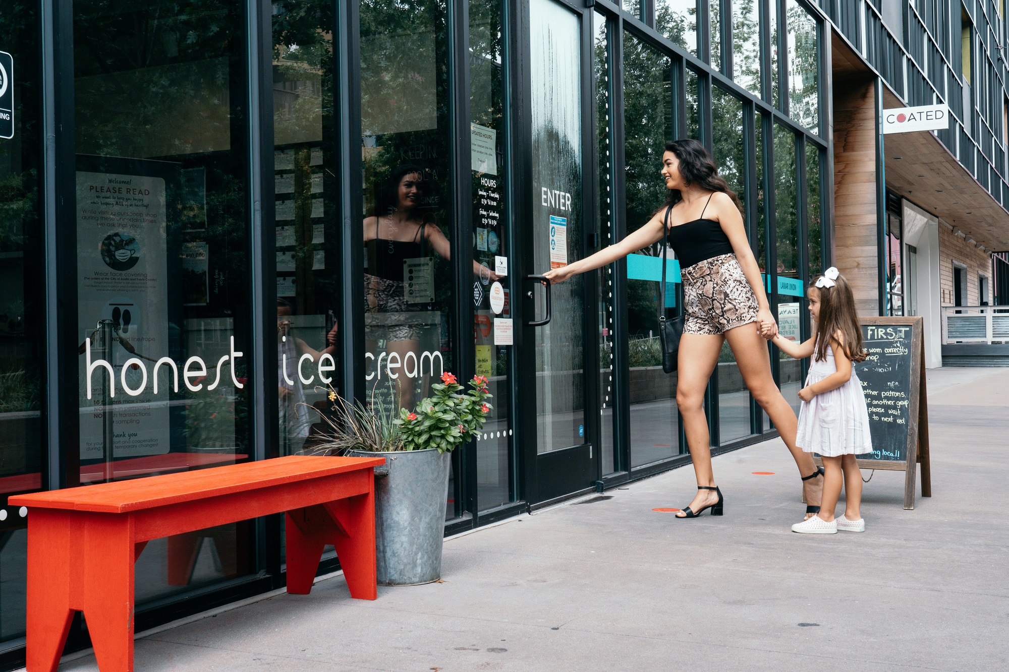 Mom and daughter entering Honest Ice Creams shop
